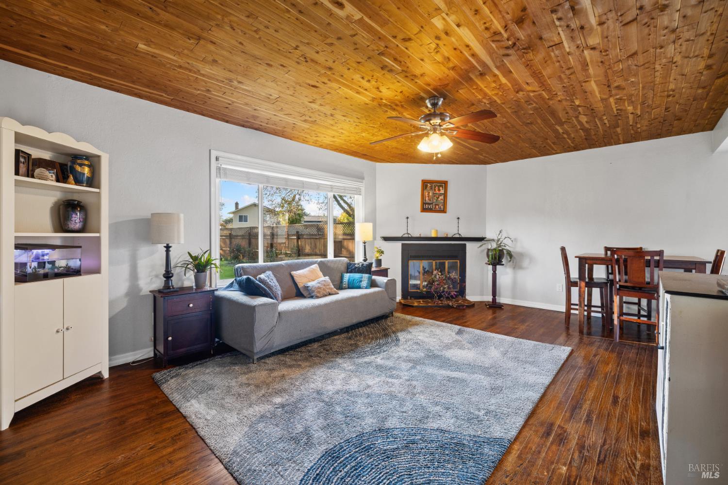 2825 Seneca Lane Santa Rosa, CA 95403 - Photo 7 of 43 This gorgeous, large living room has hard wood floors, fireplace and custom wood ceiling complete with ceiling fan.