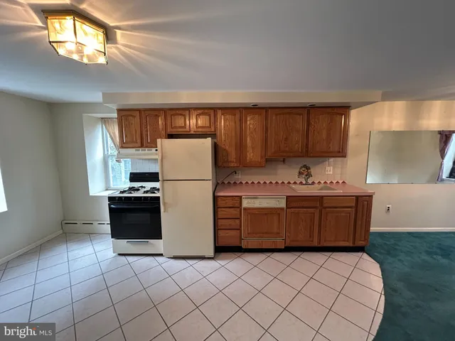 a kitchen with a refrigerator sink and stove