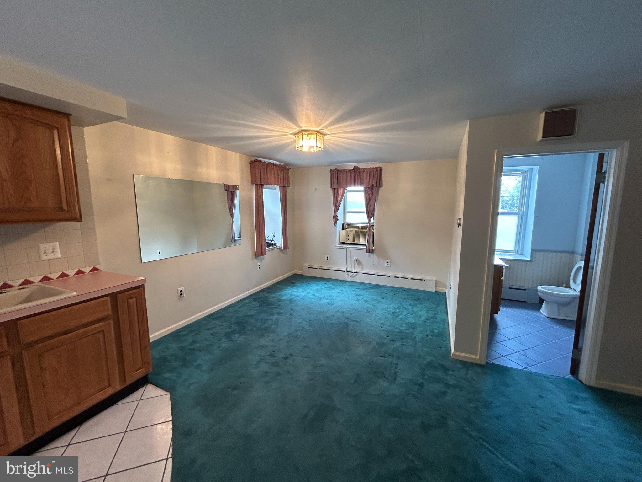 6502 Ridge Avenue, Unit 2 Philadelphia, PA 19128 - Photo 4 of 12 a view of a kitchen with cabinets and wooden floor