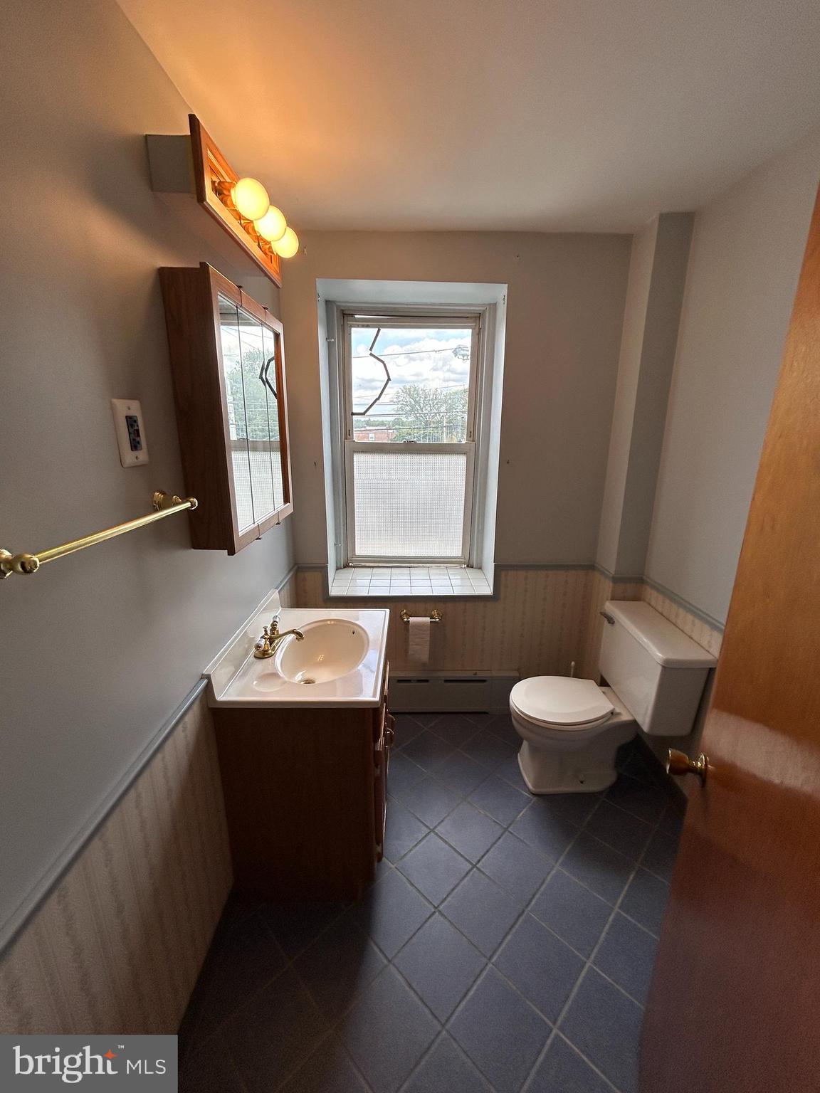 6502 Ridge Avenue, Unit 2 Philadelphia, PA 19128 - Photo 5 of 12 a bathroom with a toilet sink and mirror