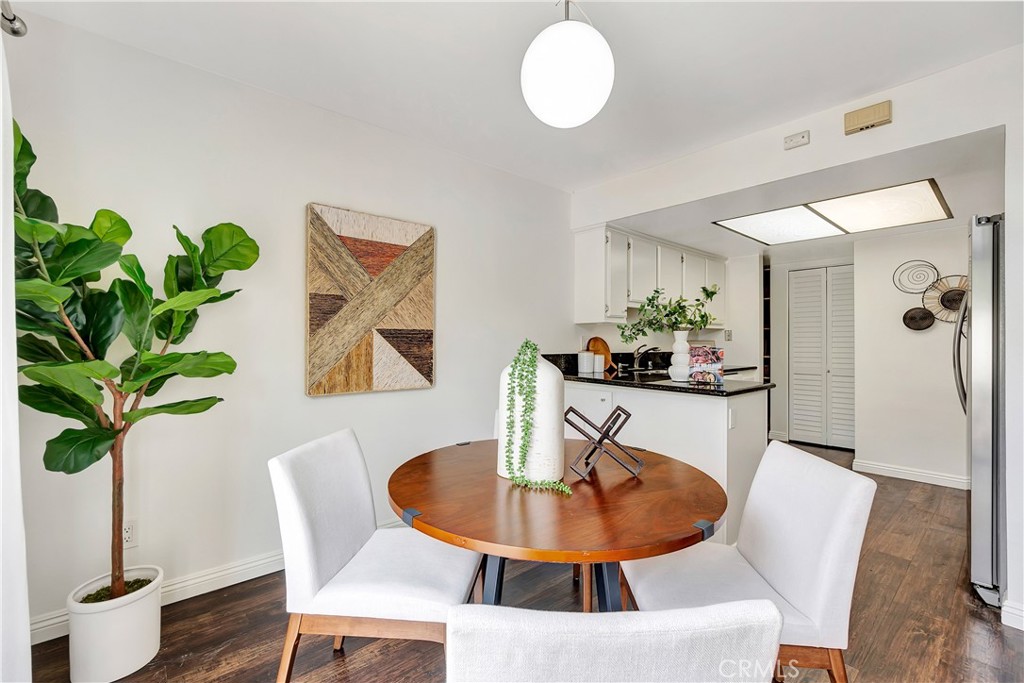 2245 Cheyenne Way, Unit 46 Fullerton, CA 92833 - Photo 12 of 30 a dining room with furniture potted plants and wooden floor