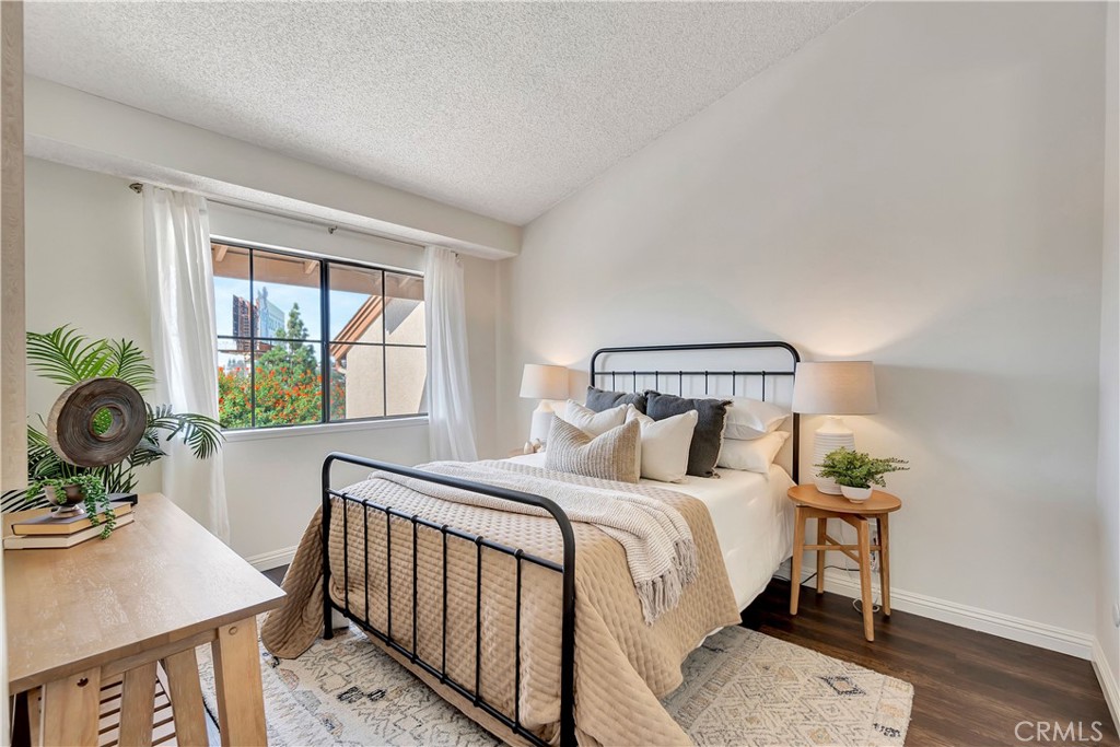 2245 Cheyenne Way, Unit 46 Fullerton, CA 92833 - Photo 14 of 30 a bedroom with a bed a potted plant on table and a window