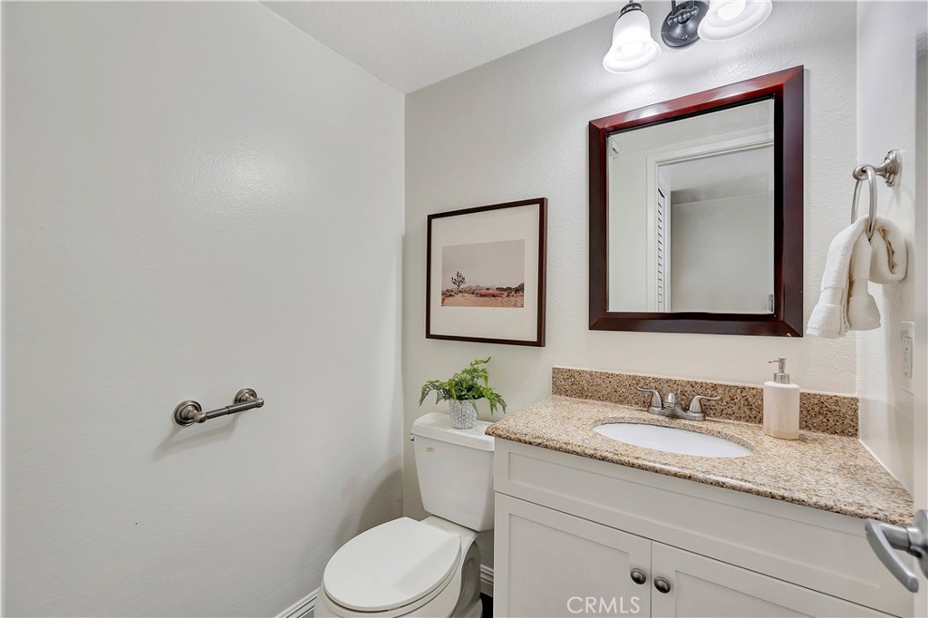 2245 Cheyenne Way, Unit 46 Fullerton, CA 92833 - Photo 22 of 30 a bathroom with a granite countertop toilet sink and mirror