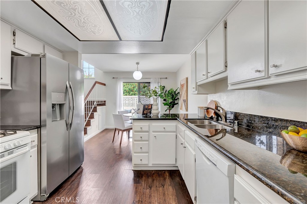 2245 Cheyenne Way, Unit 46 Fullerton, CA 92833 - Photo 6 of 30 a kitchen with a sink a refrigerator and cabinets