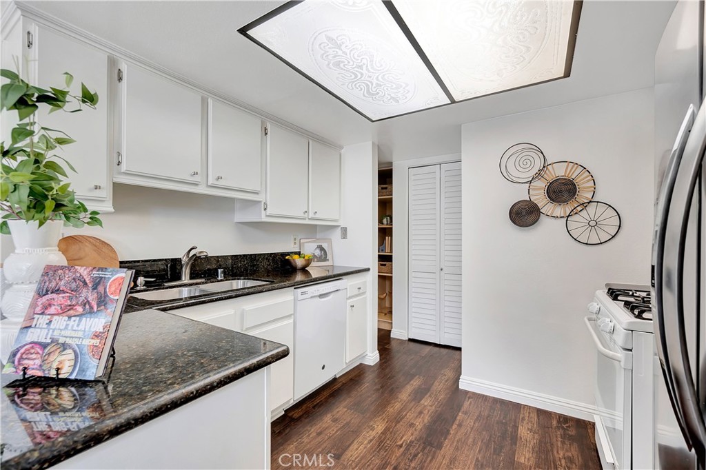 2245 Cheyenne Way, Unit 46 Fullerton, CA 92833 - Photo 8 of 30 a kitchen with stainless steel appliances granite countertop a sink stove and refrigerator