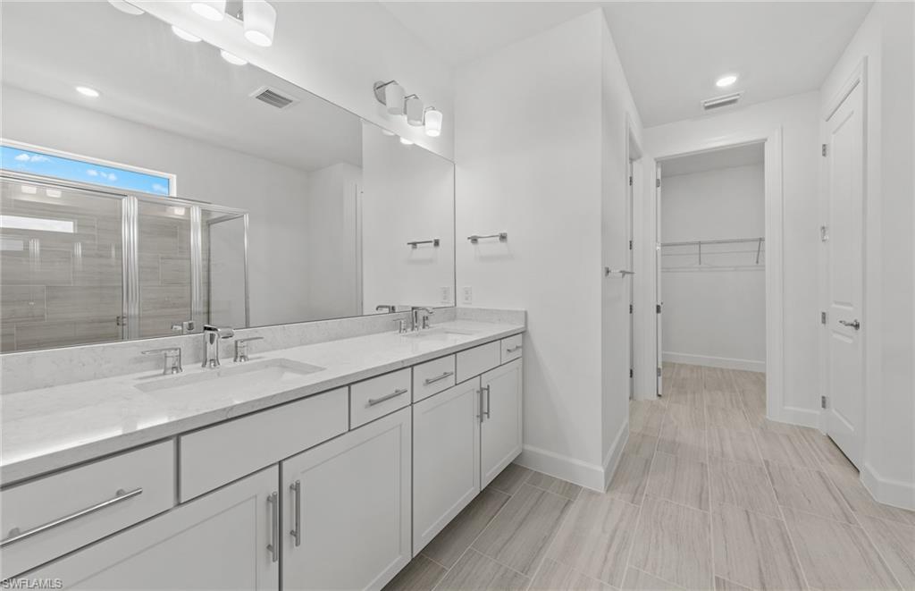 15707 Northridge Road Punta Gorda, FL 33982 - Photo 11 of 21 a bathroom with a double vanity sink and mirror