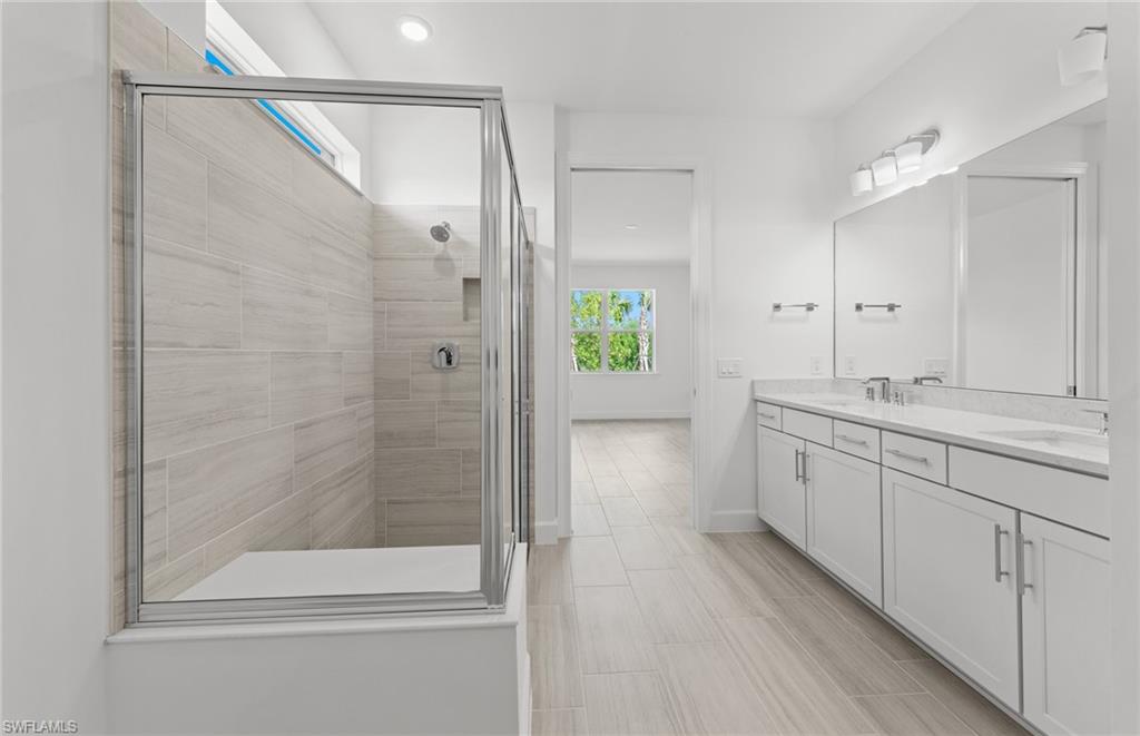 15707 Northridge Road Punta Gorda, FL 33982 - Photo 12 of 21 a bathroom with a shower sink and mirror