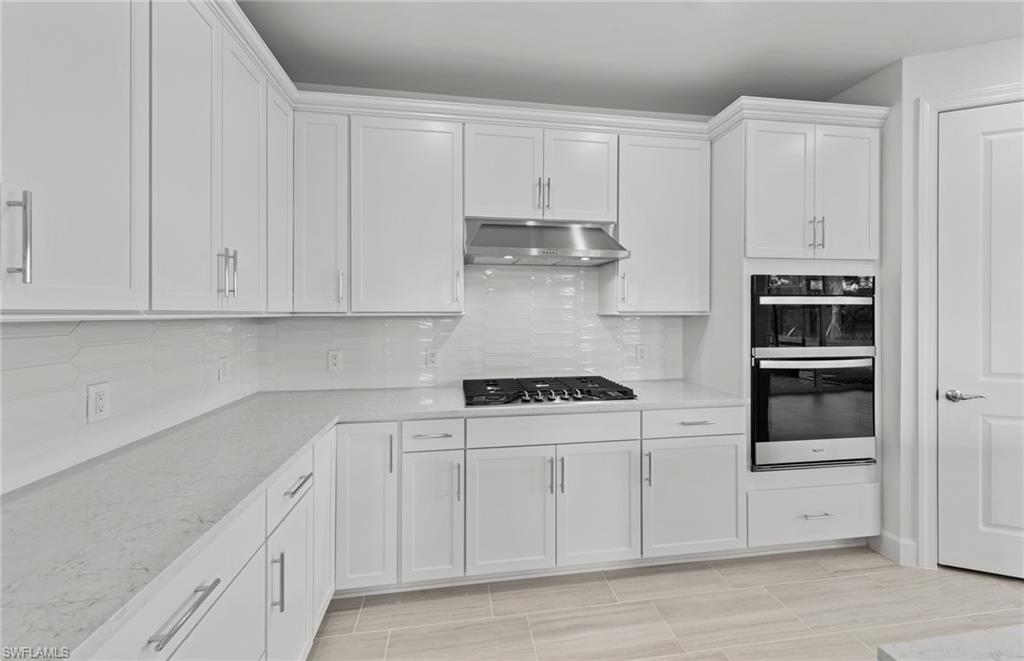 15707 Northridge Road Punta Gorda, FL 33982 - Photo 4 of 21 a kitchen with stainless steel appliances granite countertop white cabinets and a stove