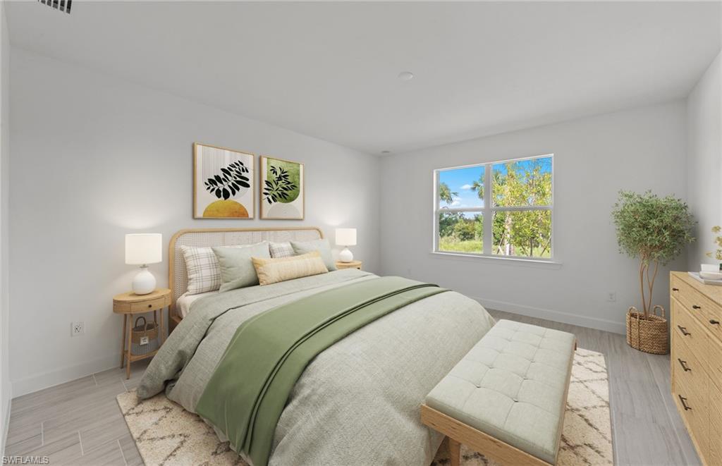 15707 Northridge Road Punta Gorda, FL 33982 - Photo 9 of 21 a bedroom with a bed and a painting on the wall