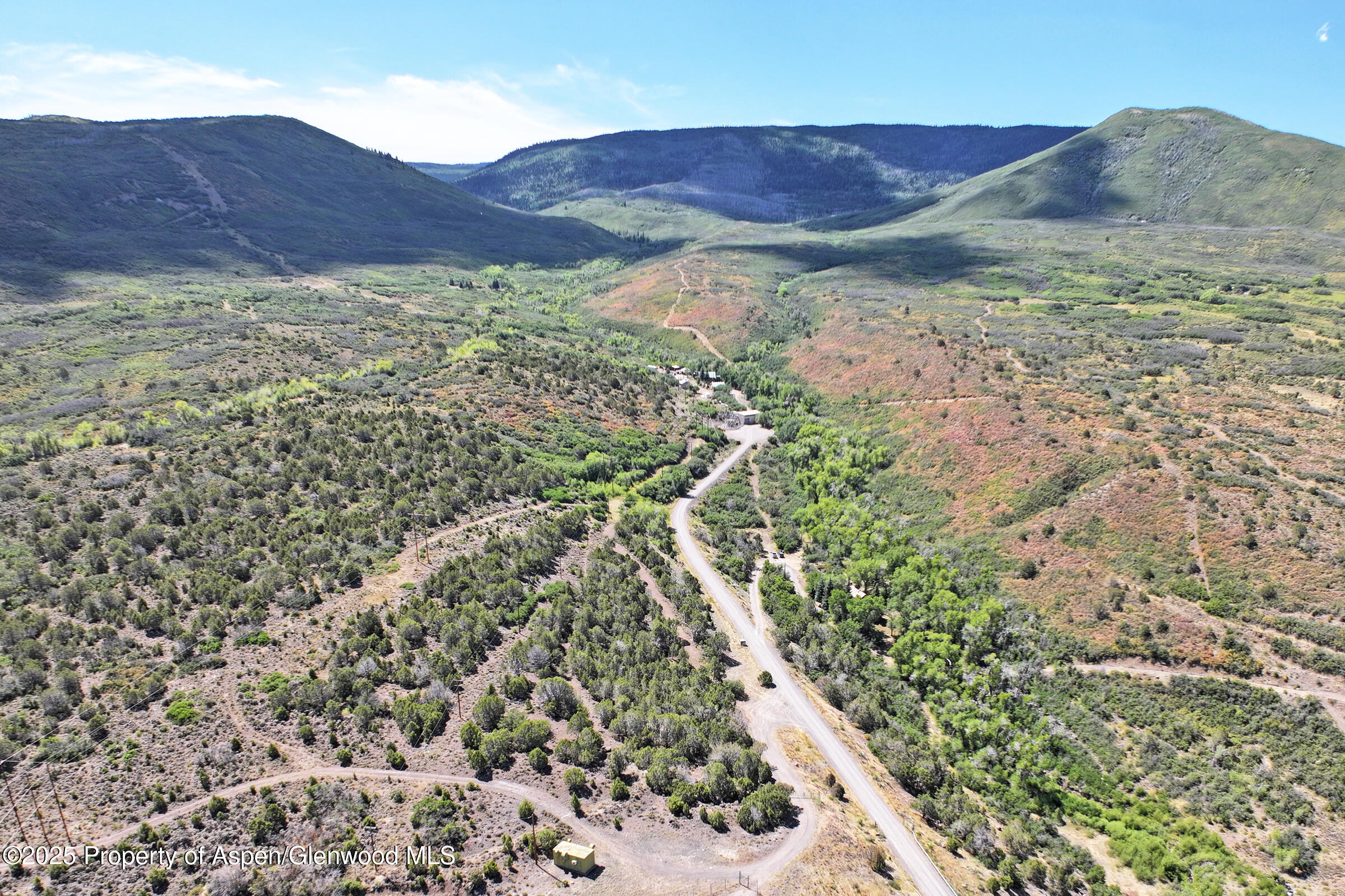 9681 54 7/10 Road Molina, CO 81646 - Photo 38 of 39 a view of a lush green hillside and a houses