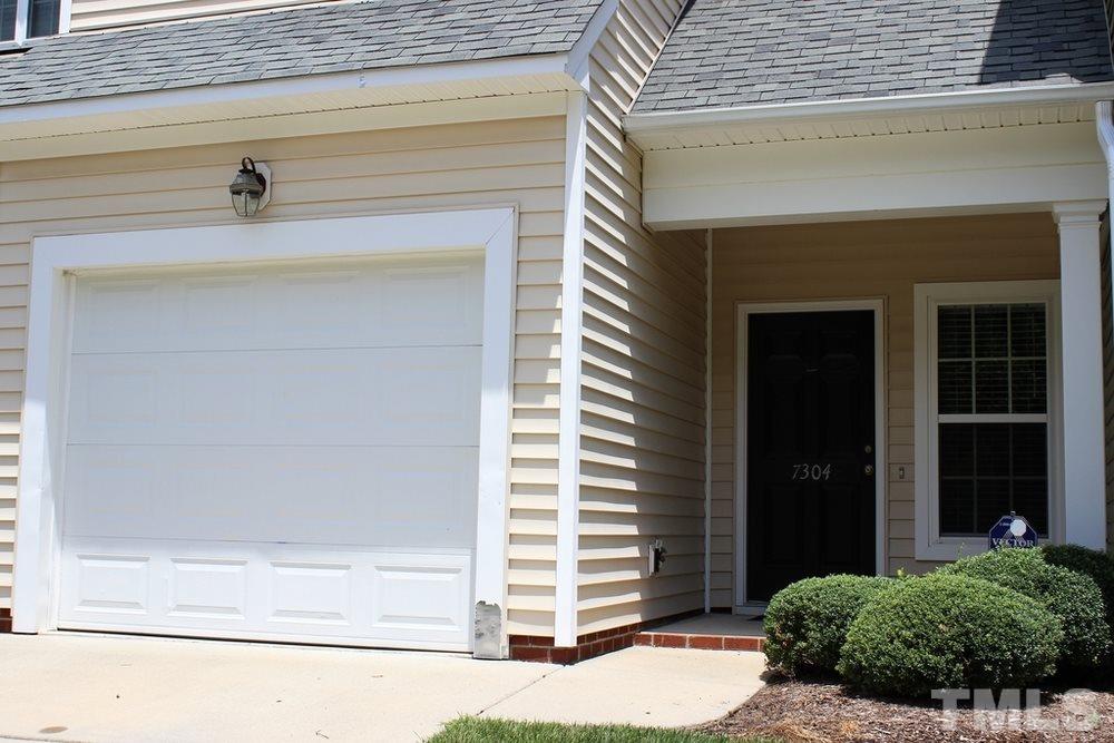 7304 Caversham Way Raleigh, NC 27617 - Photo 1 of 22 a front view of a house with a garage