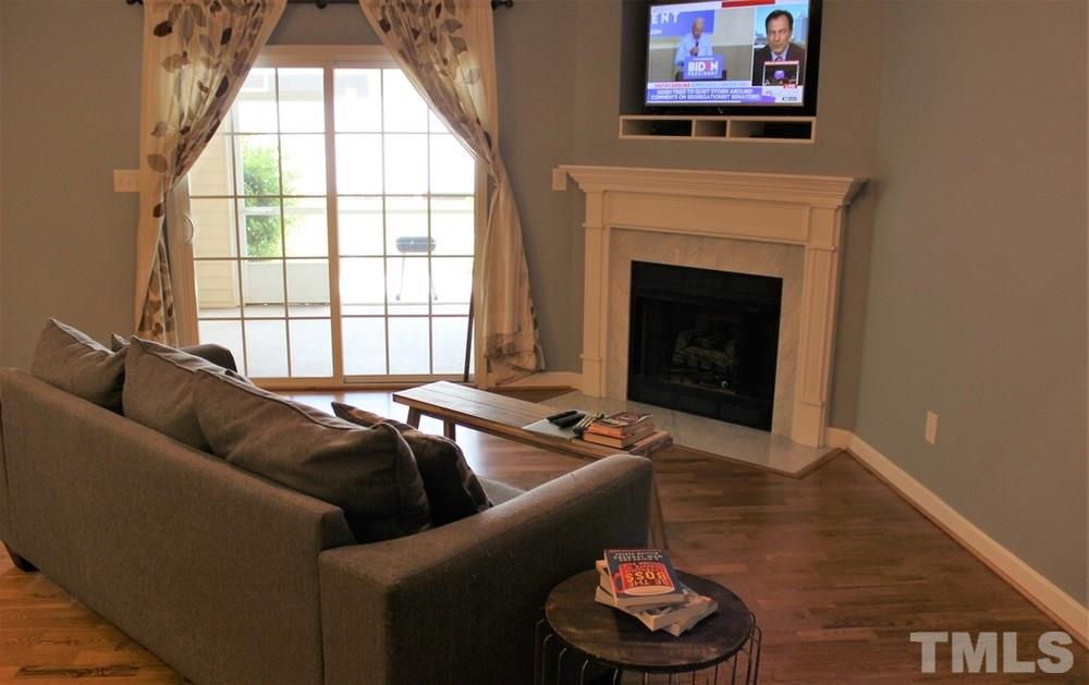 7304 Caversham Way Raleigh, NC 27617 - Photo 11 of 22 a living room with furniture and a fireplace