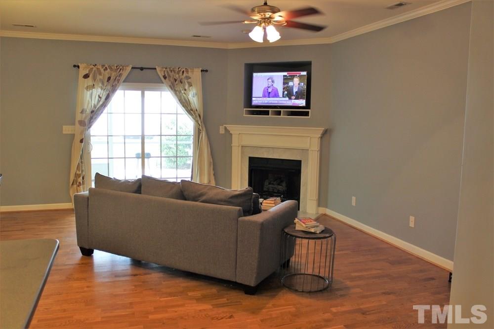 7304 Caversham Way Raleigh, NC 27617 - Photo 12 of 22 a living room with furniture and a fireplace