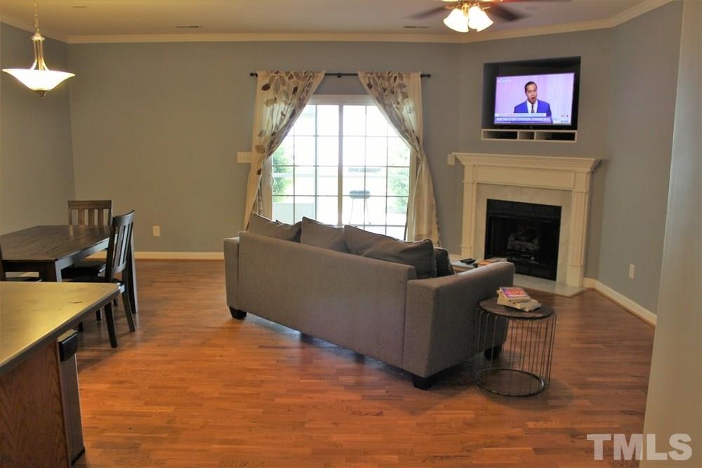 7304 Caversham Way Raleigh, NC 27617 - Photo 13 of 22 a living room with furniture and a fireplace