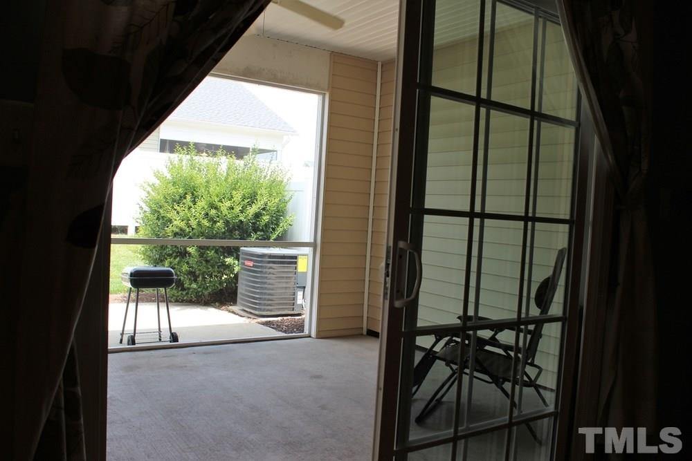 7304 Caversham Way Raleigh, NC 27617 - Photo 14 of 22 a view of a porch with chairs and backyard of the house