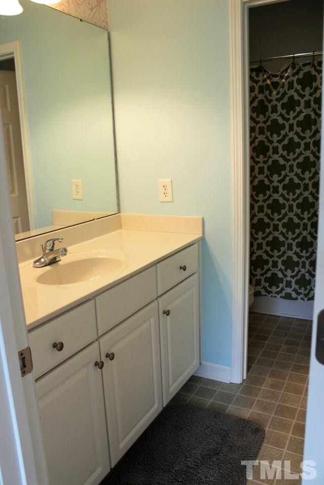 7304 Caversham Way Raleigh, NC 27617 - Photo 16 of 22 a bathroom with a sink and a mirror