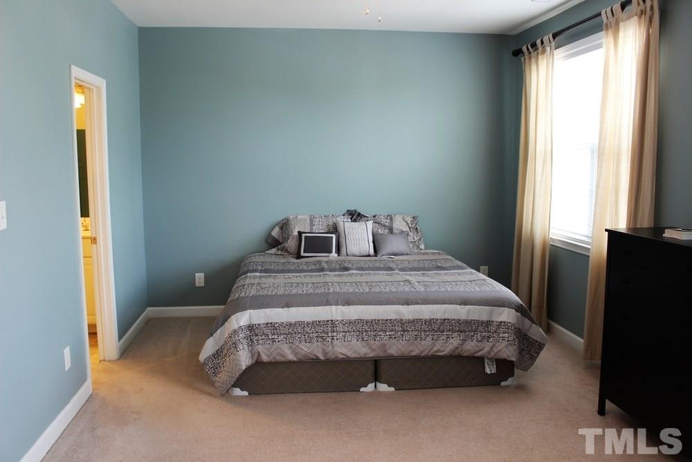 7304 Caversham Way Raleigh, NC 27617 - Photo 19 of 22 a bedroom with a bed and a window