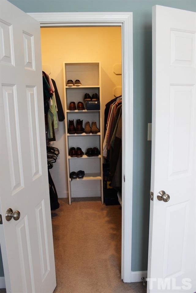 7304 Caversham Way Raleigh, NC 27617 - Photo 20 of 22 a view of walk in closet with clothes and shoes