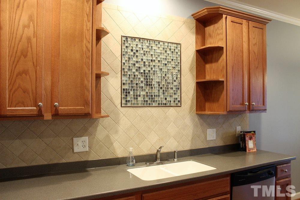 7304 Caversham Way Raleigh, NC 27617 - Photo 3 of 22 a bathroom with a sink and a mirror