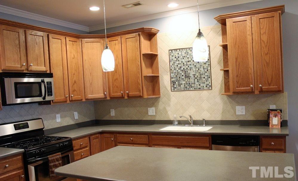 7304 Caversham Way Raleigh, NC 27617 - Photo 5 of 22 a kitchen with a refrigerator a sink and a stove