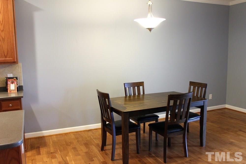 7304 Caversham Way Raleigh, NC 27617 - Photo 7 of 22 a view of a dining room with furniture and wooden floor