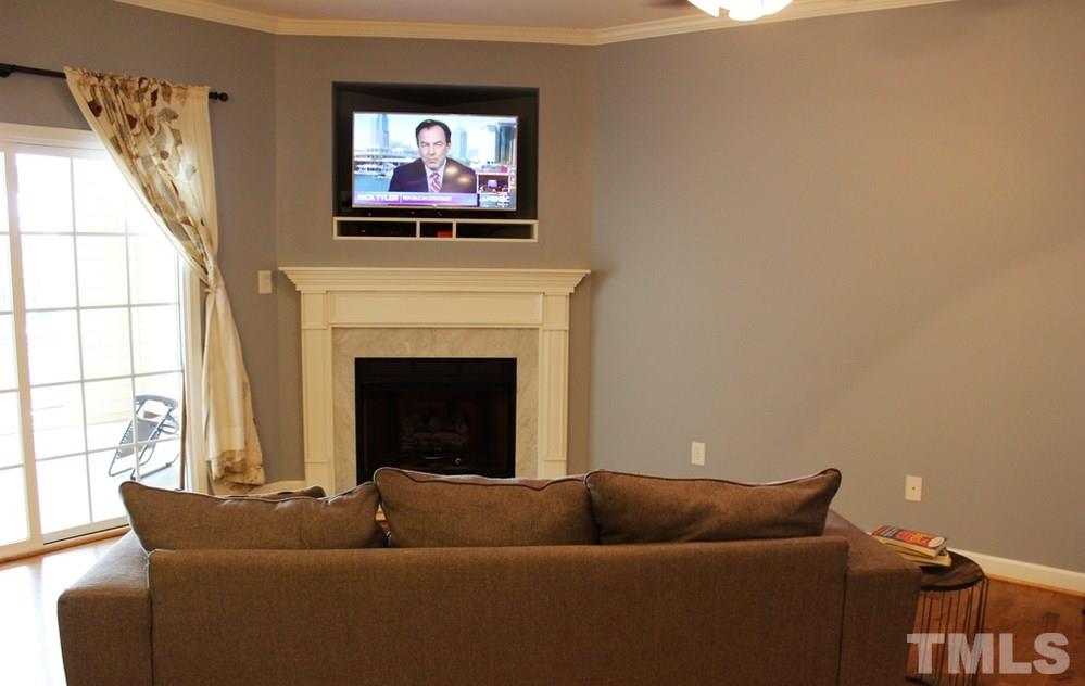 7304 Caversham Way Raleigh, NC 27617 - Photo 10 of 22 a living room with furniture and a fireplace