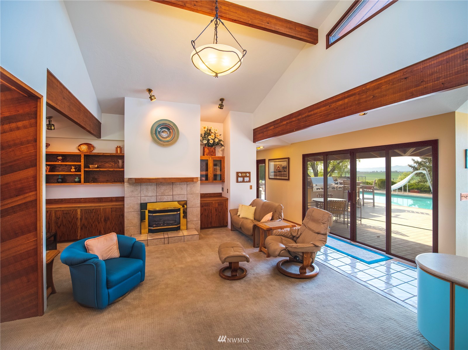 11549 Rd E Southwest Royal City, WA 99357 - Photo 11 of 30 a living room with furniture a fireplace and a floor to ceiling window