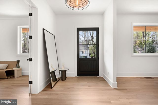 a view of an entryway with wooden floor and door