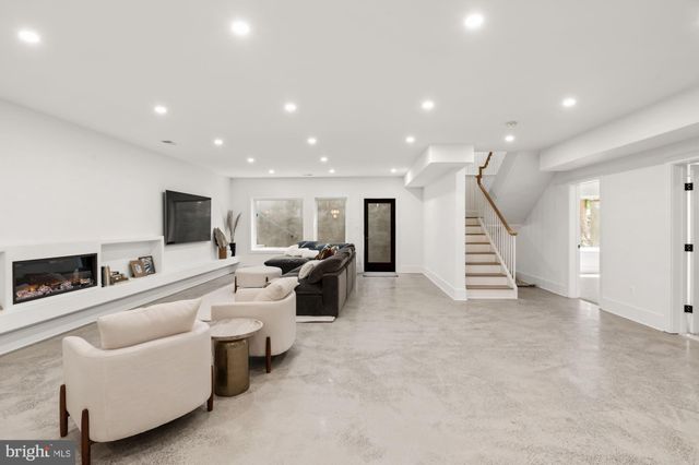 a bathroom with a sink a toilet a mirror and shower