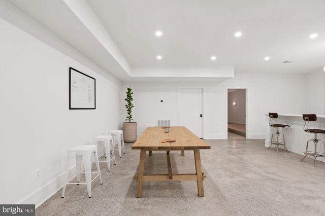 a front view of a house with yard and sitting area