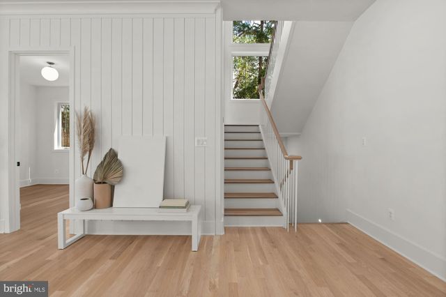 a view of a bedroom with wooden floor and stairs