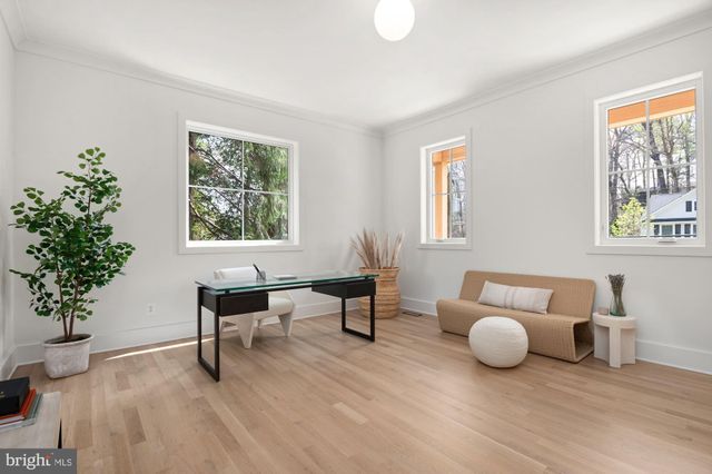 a living room with furniture a fireplace and a table
