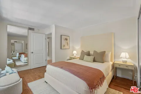 a bedroom with a bed and a lamp