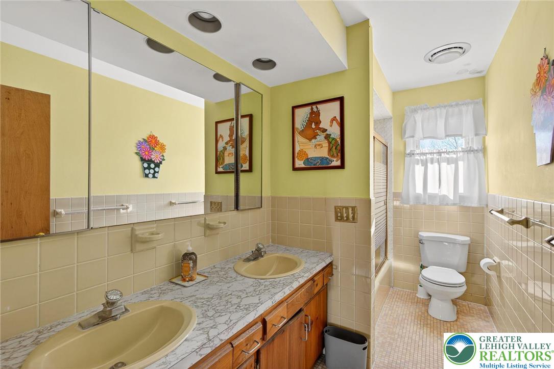 5424 Clauser Road Orefield, PA 18069 - Photo 19 of 31 a bathroom with a granite countertop double vanity sink mirror and toilet