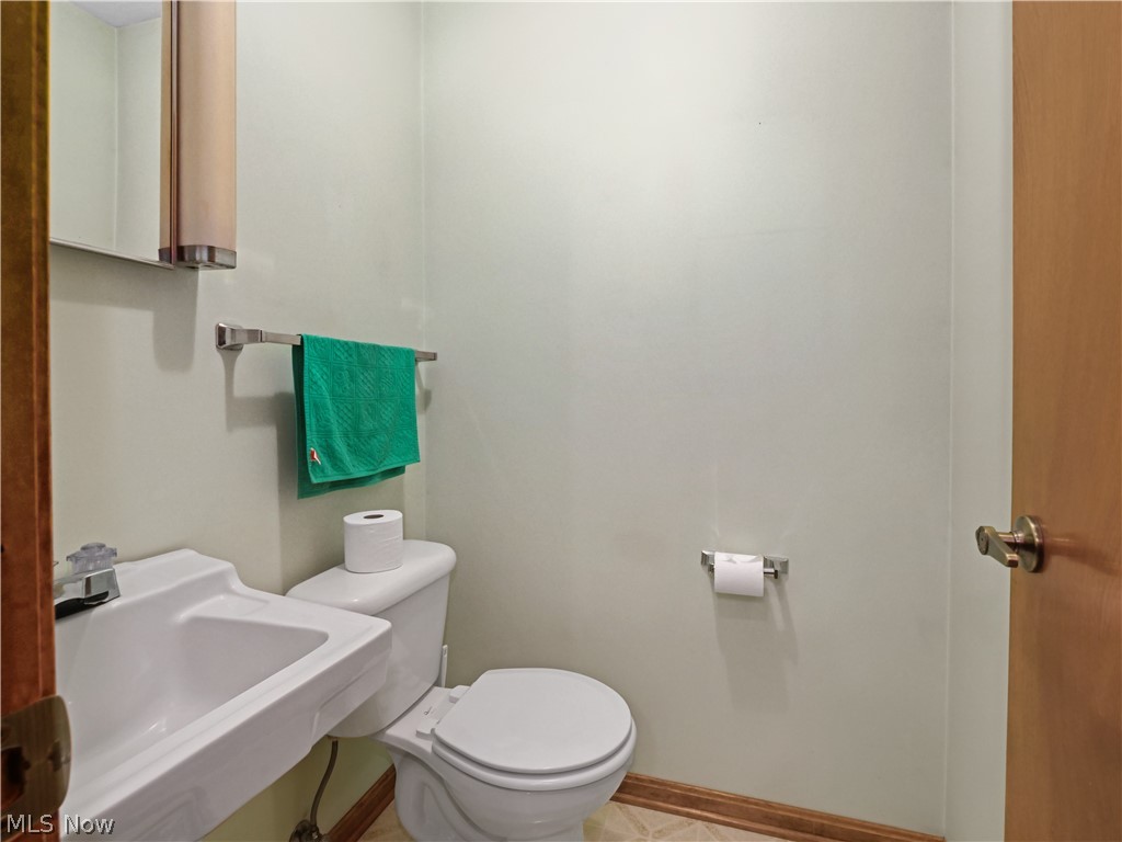 5175 Case Road North Ridgeville, OH 44039 - Photo 22 of 28 Bathroom featuring toilet, tile floors, and sink