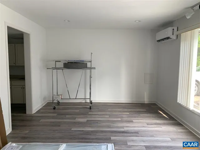 a view of a room with wooden floor