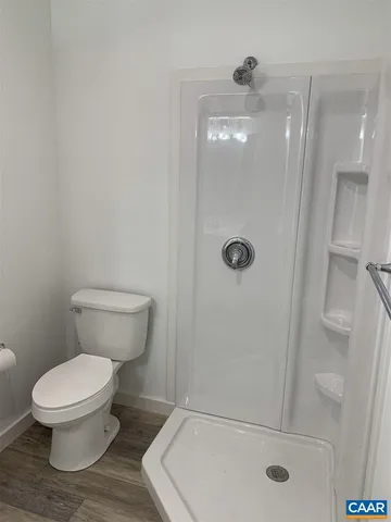 a white toilet sitting next to a bath tub and shower