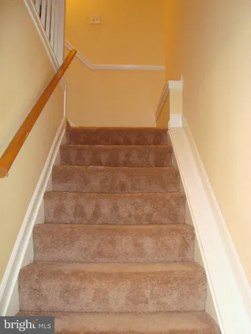 a view of staircase with white walls