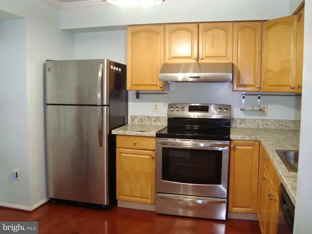 a kitchen with a refrigerator stove and sink
