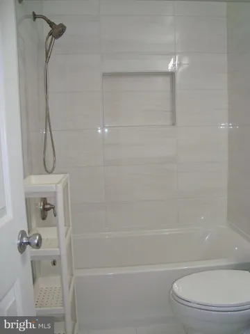 a bathroom with a toilet and shower