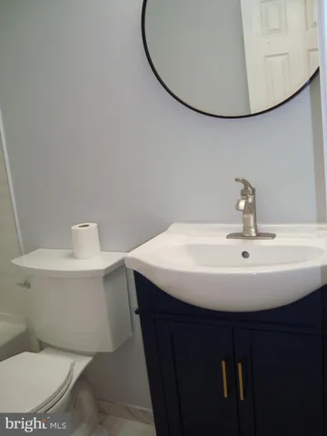 a bathroom with a sink mirror and toilet