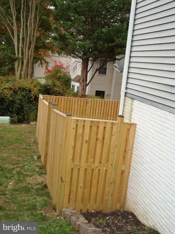 a view of outdoor space with wooden fence