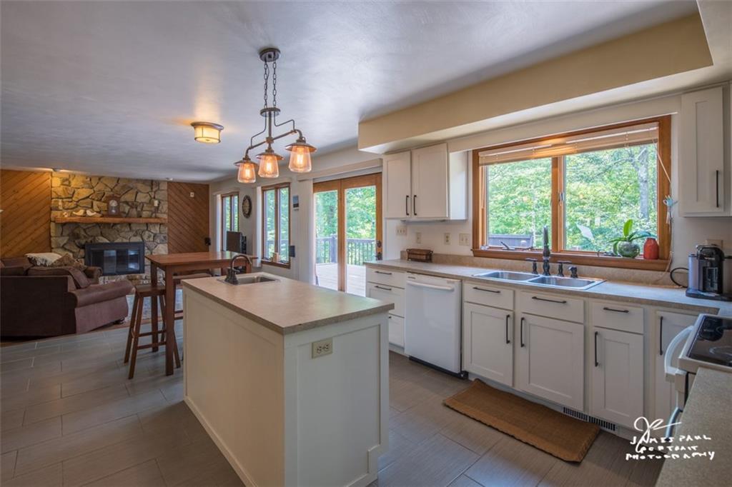 6148 Baker School Road Trafford, PA 15085 - Photo 8 of 25 Enjoy the light bright Eat in Kitchen with Center Island! New Contemporary gray ceramic flooring, resurfaced cabinets & handles! Appliances are all included!