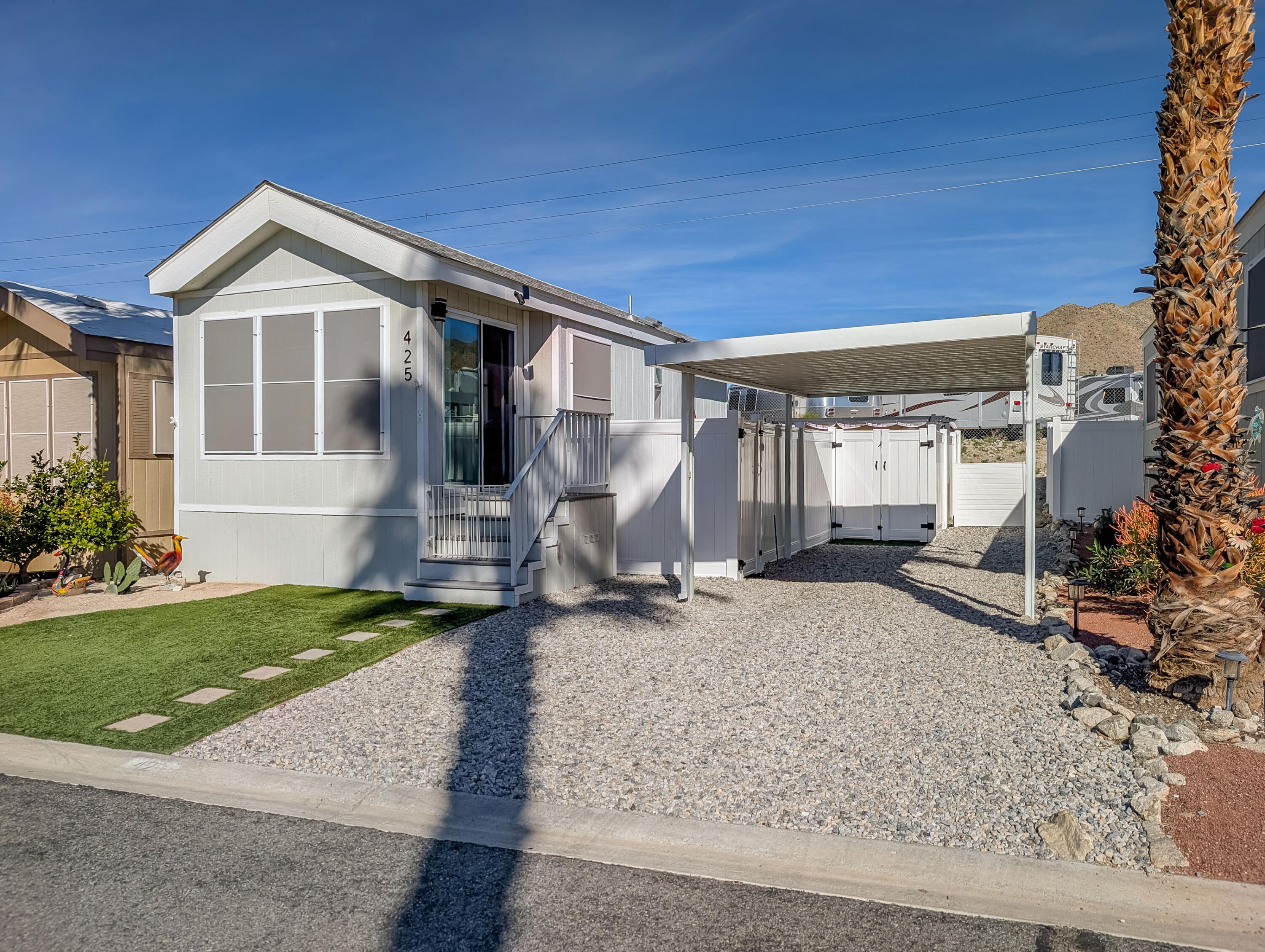 70200 Dillon Road, Unit 425 Desert Hot Springs, CA 92241 - Photo 1 of 28 a front view of a house with a yard