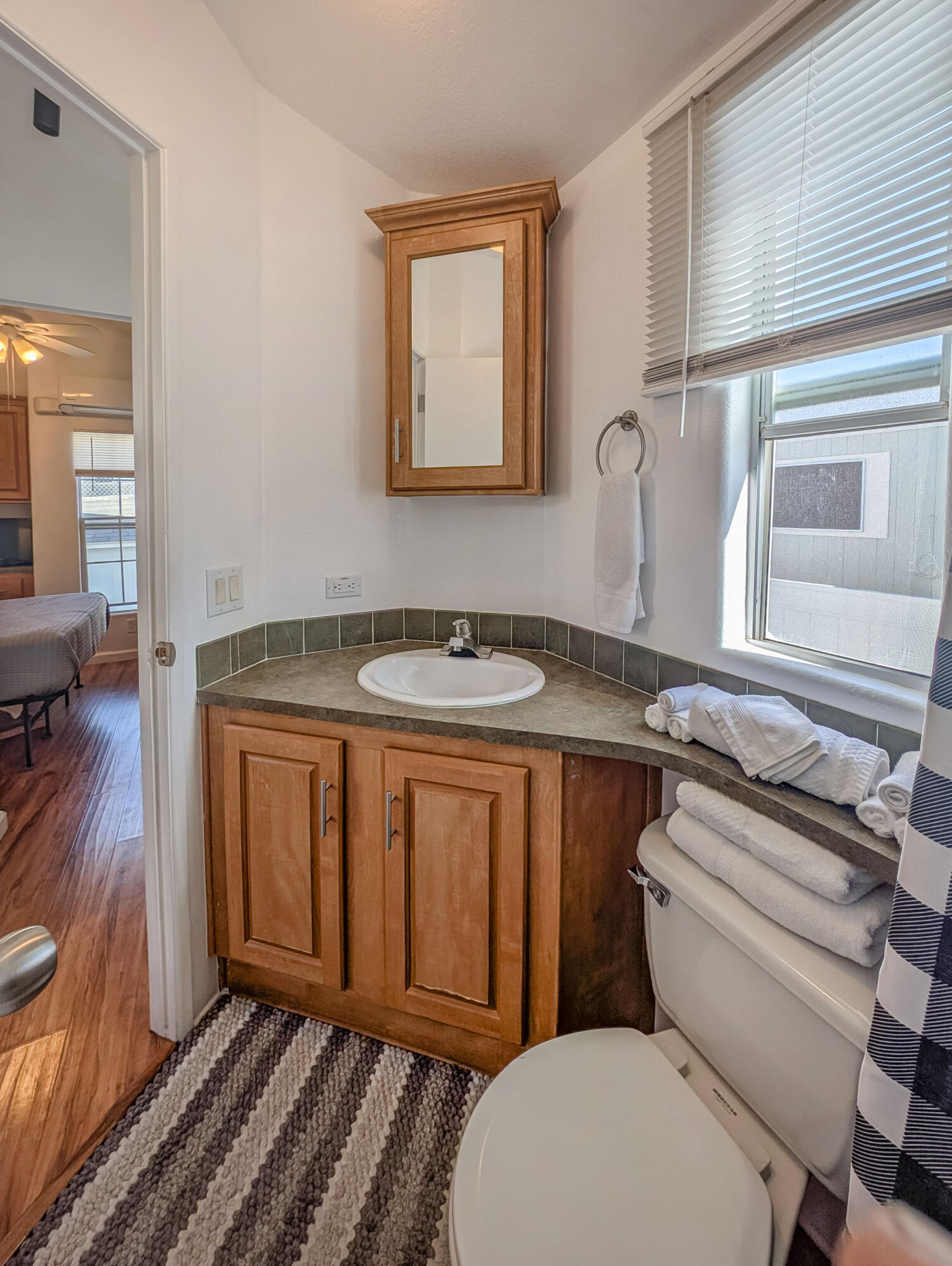 70200 Dillon Road, Unit 425 Desert Hot Springs, CA 92241 - Photo 12 of 28 a bathroom with a granite countertop toilet sink and mirror