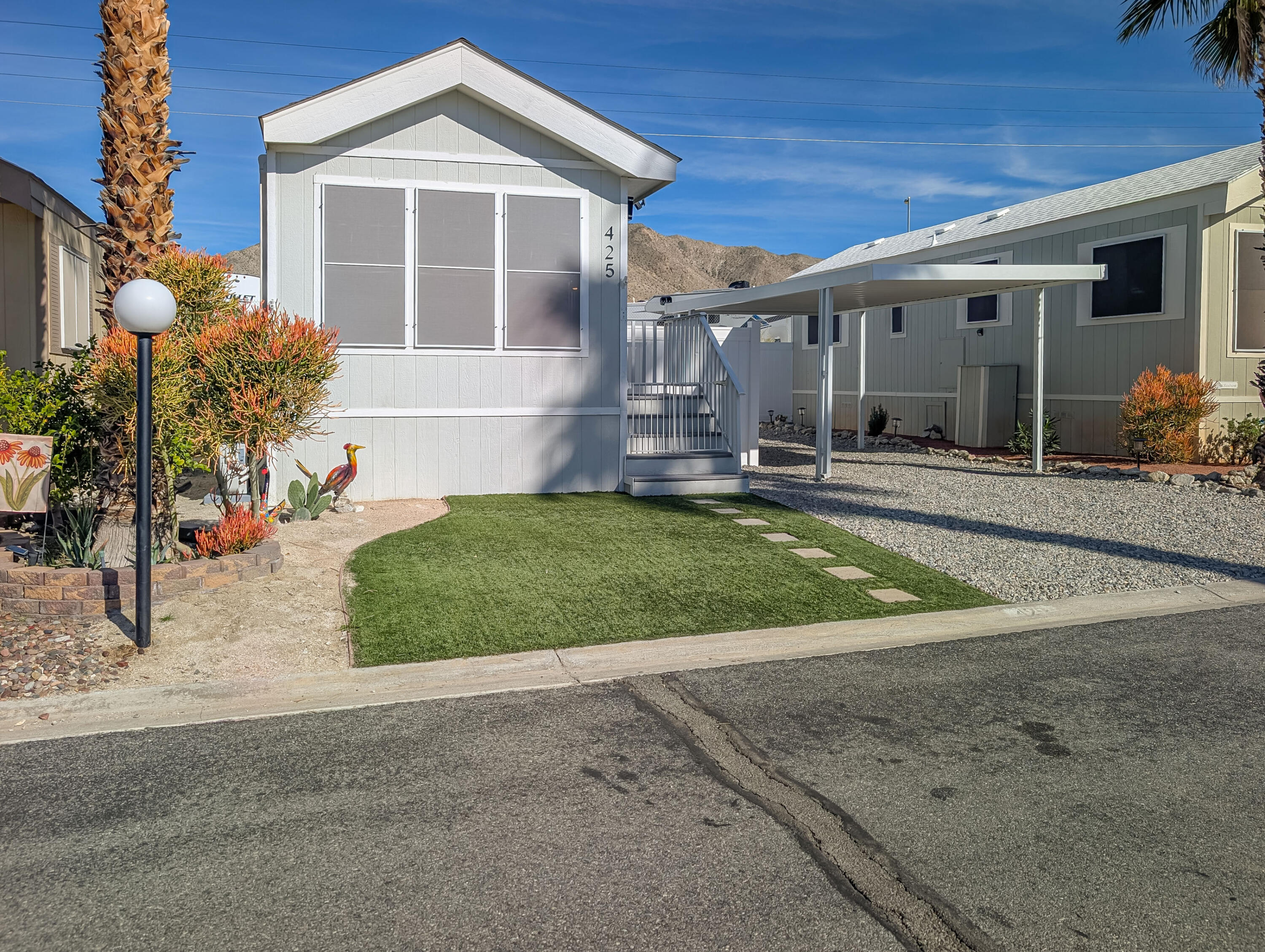 70200 Dillon Road, Unit 425 Desert Hot Springs, CA 92241 - Photo 2 of 28 a front view of a house with a yard