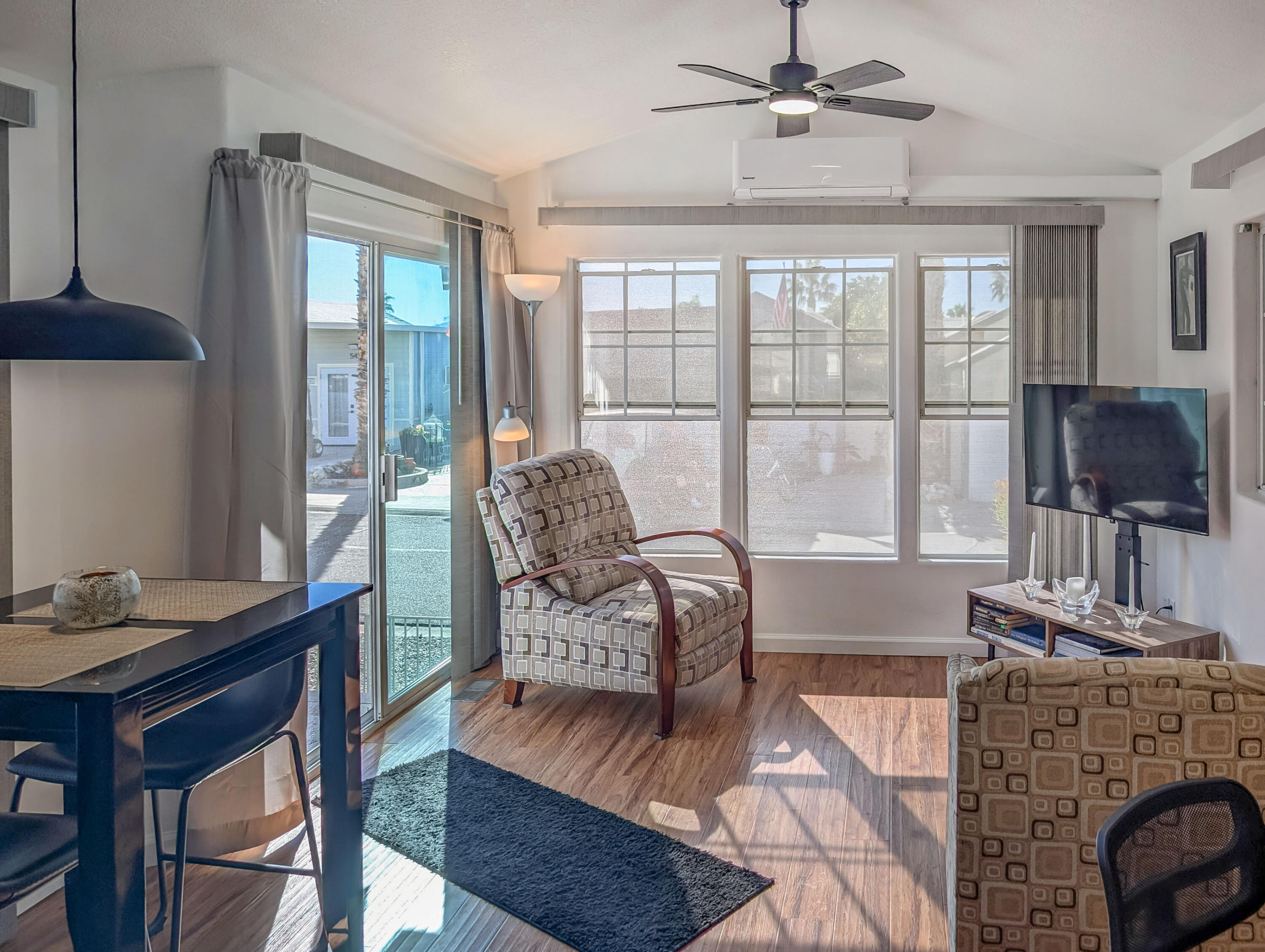 70200 Dillon Road, Unit 425 Desert Hot Springs, CA 92241 - Photo 5 of 28 a living room with furniture a flat screen tv and a large window