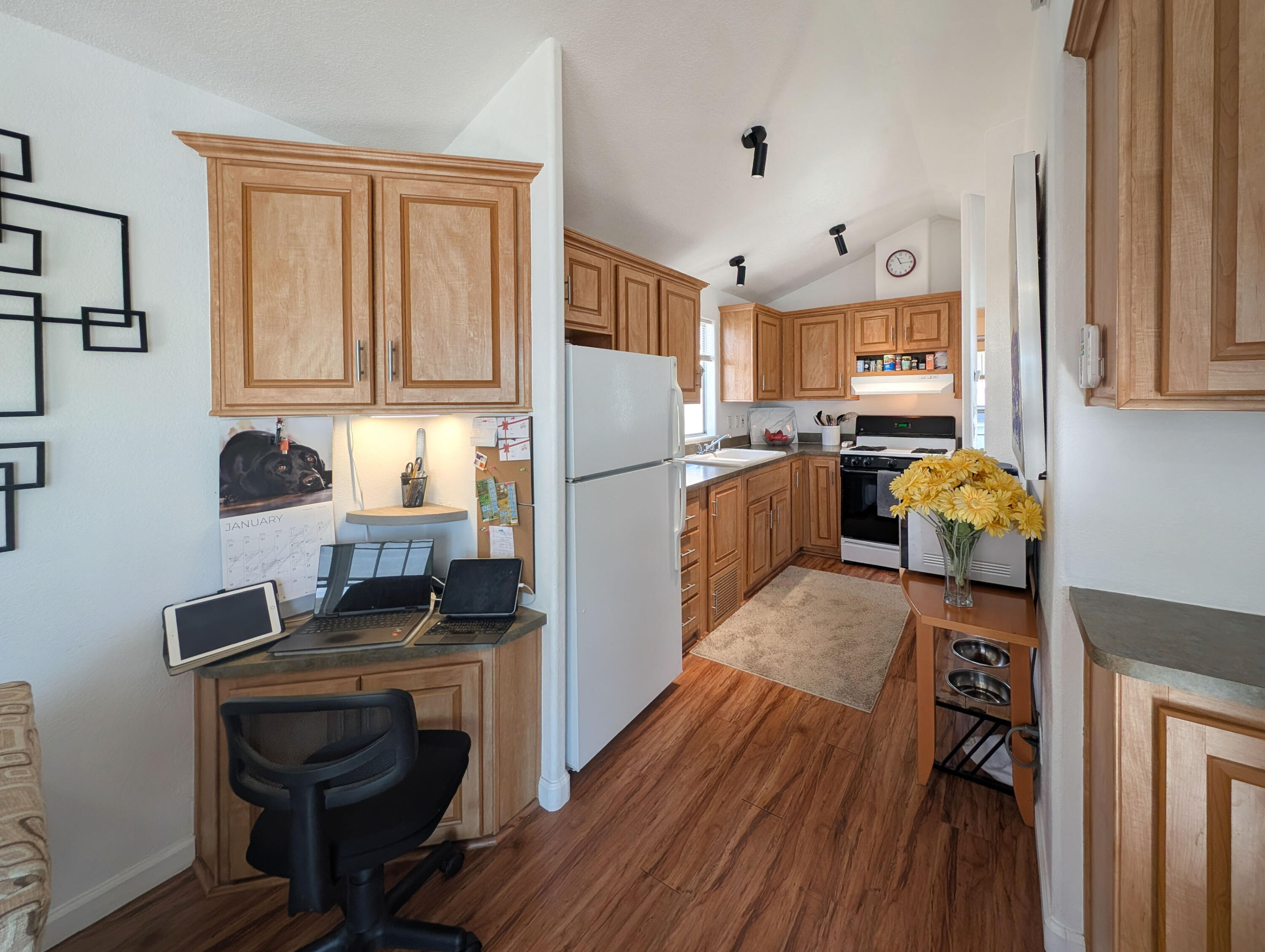 70200 Dillon Road, Unit 425 Desert Hot Springs, CA 92241 - Photo 7 of 28 a kitchen with a refrigerator and a stove top oven