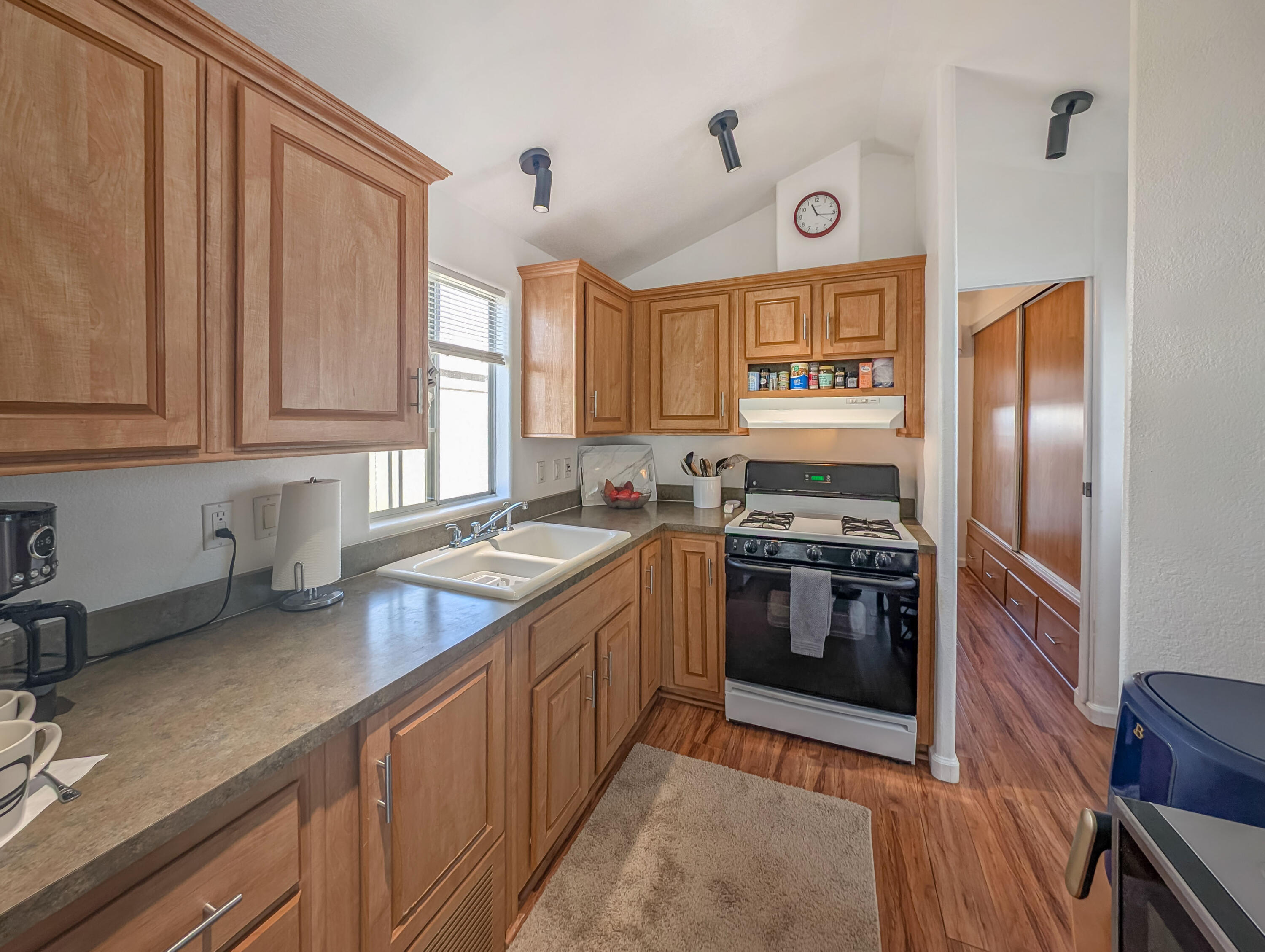 70200 Dillon Road, Unit 425 Desert Hot Springs, CA 92241 - Photo 8 of 28 a kitchen with stainless steel appliances granite countertop a sink stove and cabinets