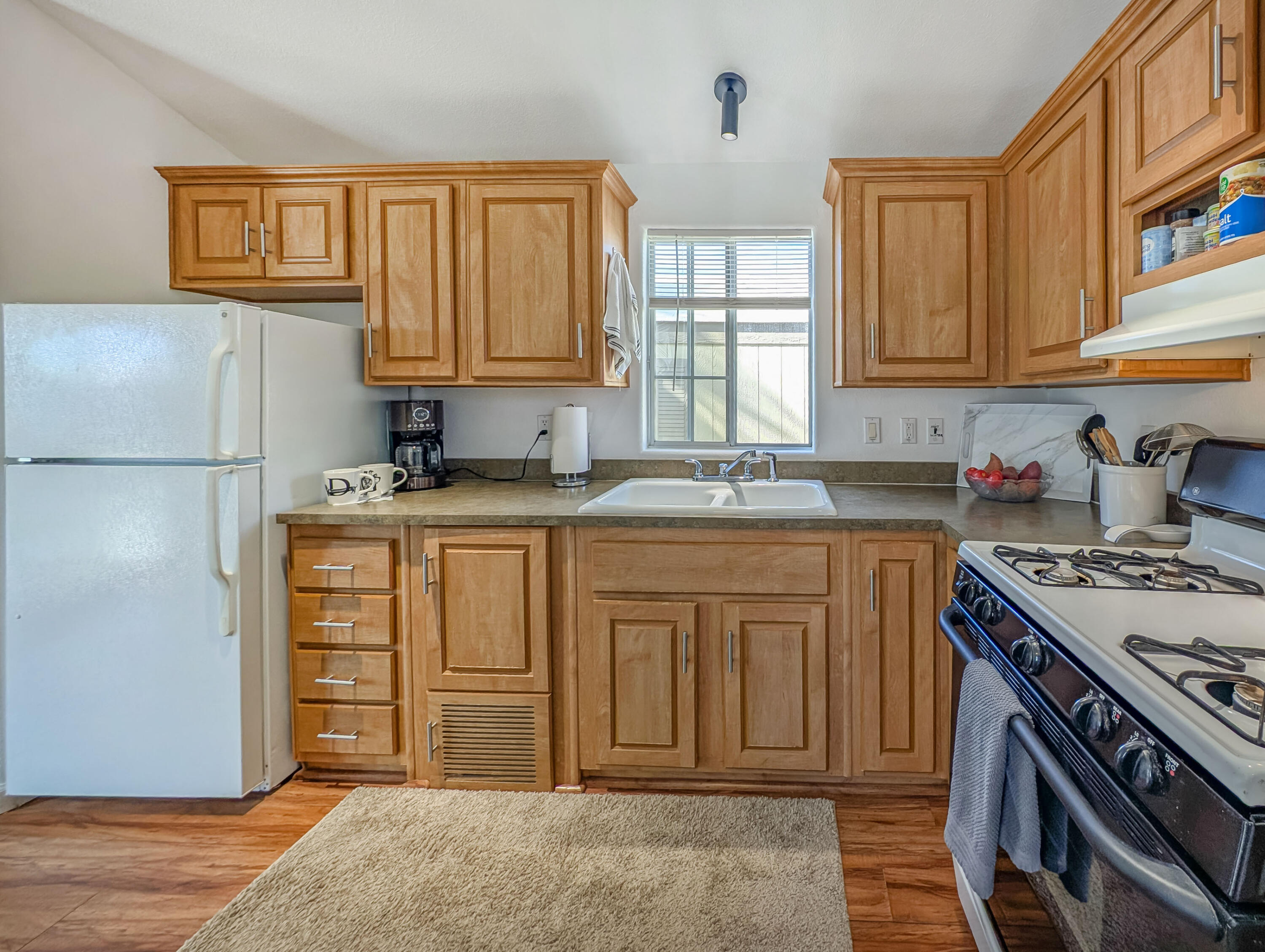 70200 Dillon Road, Unit 425 Desert Hot Springs, CA 92241 - Photo 9 of 28 a kitchen with stainless steel appliances granite countertop a sink stove and cabinets